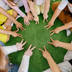 group of children playing together and stating the peace sign